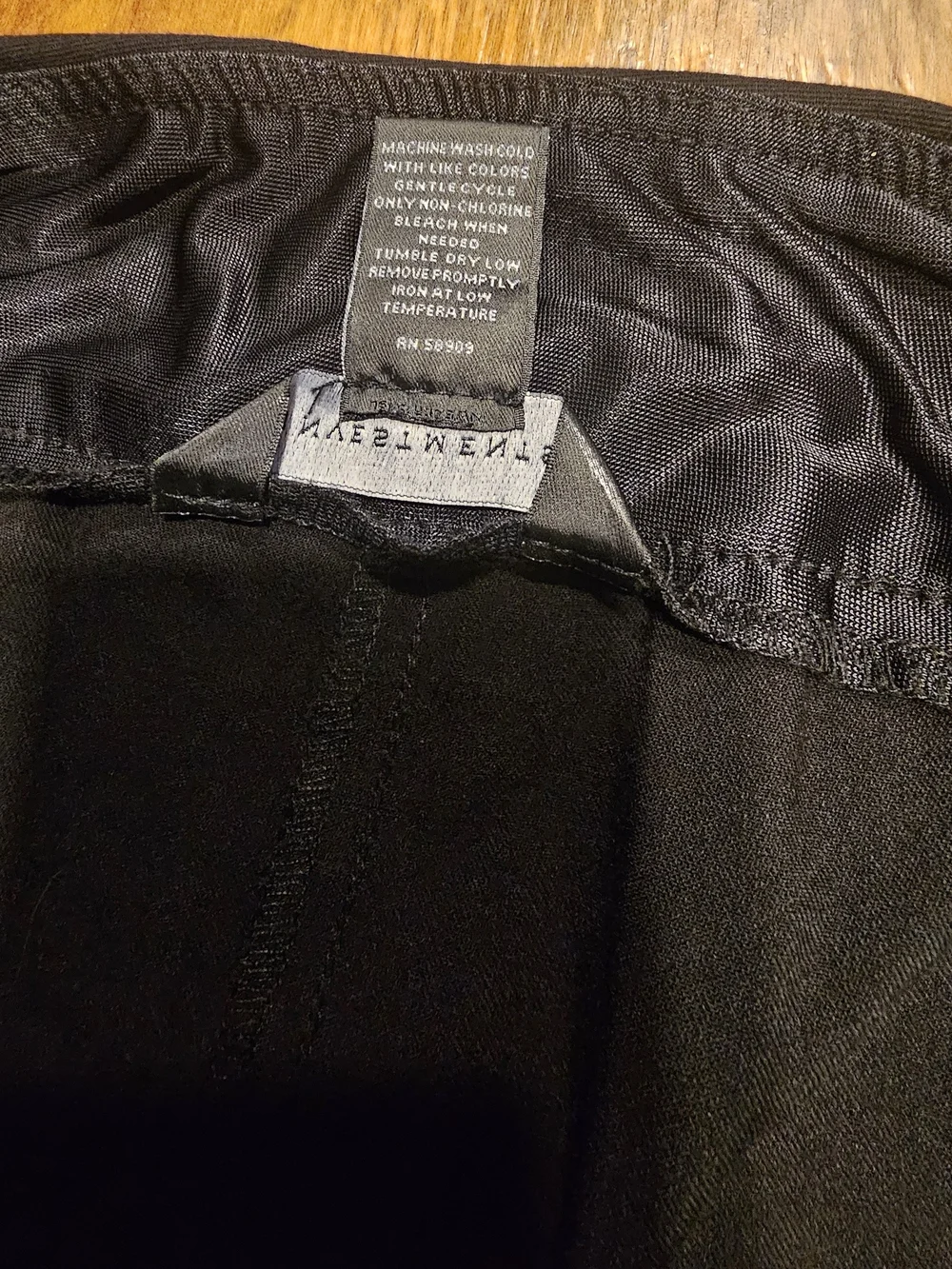 C3, The product is a pair of black dress pants for women by the brand Investment